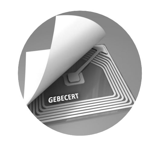 Macro photograph of a GeBeCert chip with a concealed antenna coil under a peel-back label